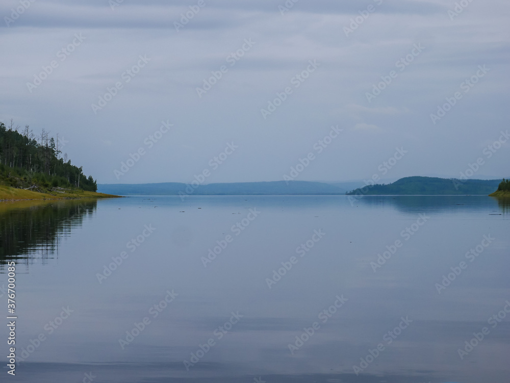 Landscape of calm water of the river the hills and the sky