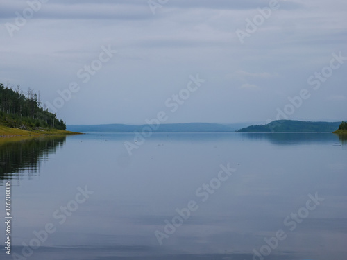 Landscape of calm water of the river the hills and the sky