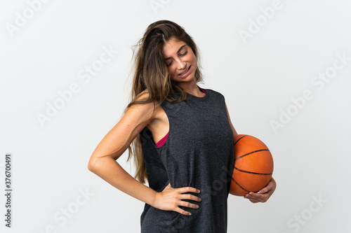 Young woman playing basketball isolated on white background suffering from backache for having made an effort