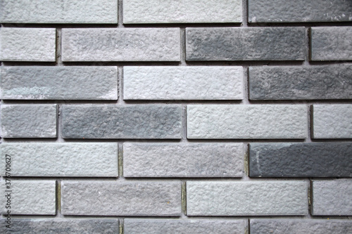 Rough surface of bricks or tiles wall in random grey color patterns, close up image for interior and decoration material.