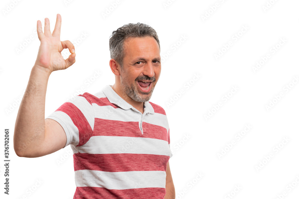 White man smiling showing okay gesture with copyspace White man smiling showing okay gesture with copyspace