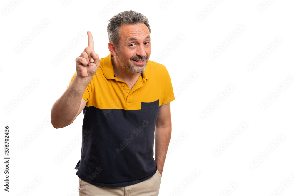 Smiling adult man making idea gesture using index finger Smiling adult man making idea gesture using index finger