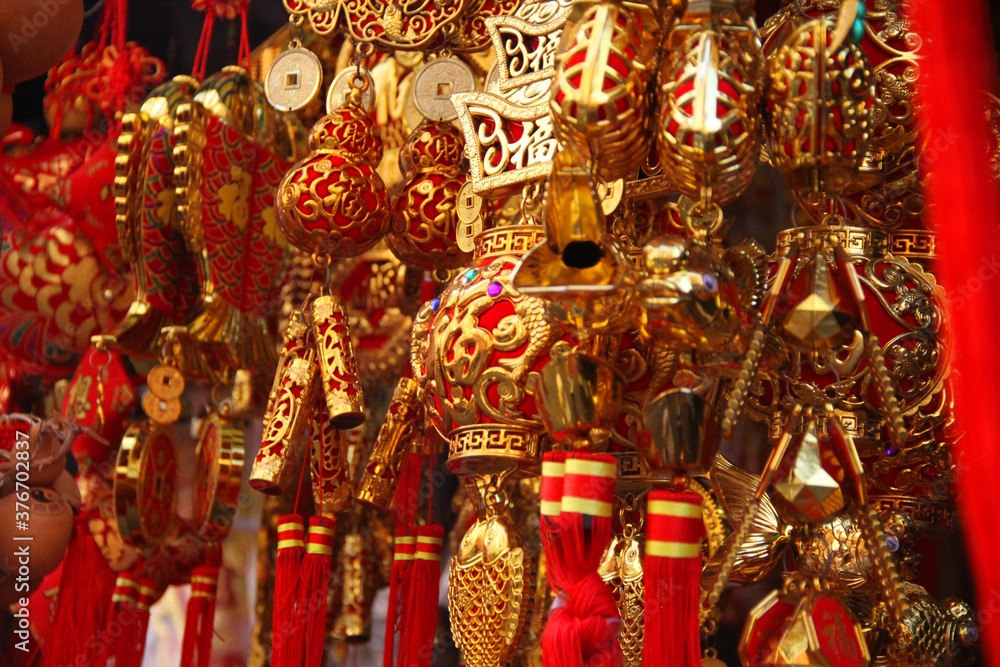 Close up of Chinese lucky charms for good luck, Red knotted ornaments and Gold coins, fish and lantern, Concept image for Chinese festival and new year souvenir.  