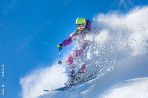 Girl skiing through the fresh snow