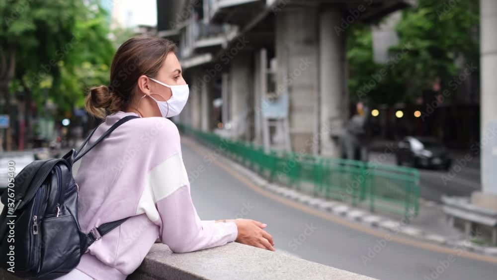 Lifestyle new normal concept. Young caucasian traveller woman with backpack and mask protect virus. Backpack traveling in city destination landmark Lifestyle new normal concept. Young caucasian traveller woman with backpack and mask protect virus. Backpack traveling in city destination landmark