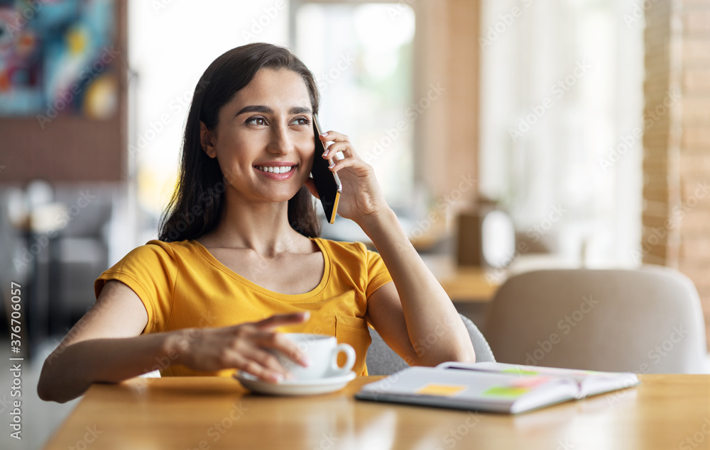 Smiling beautiful girl having conversation on phone Smiling beautiful girl having conversation on phone