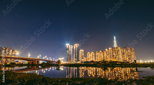 Panorama night view at Landmark 81 is a super tall skyscraper in center Ho Chi Minh City  Vietnam and Thu Thiem bridge with development buildings.