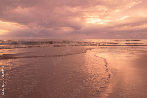 Fototapeta Naklejka Na Ścianę i Meble -  Beautiful waves on the beach with in sunrise.
