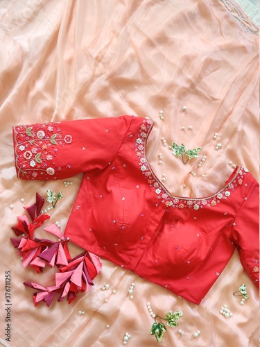 Beautiful red designer blouse with flower thread work embroidery for woman on sari by Indian designer