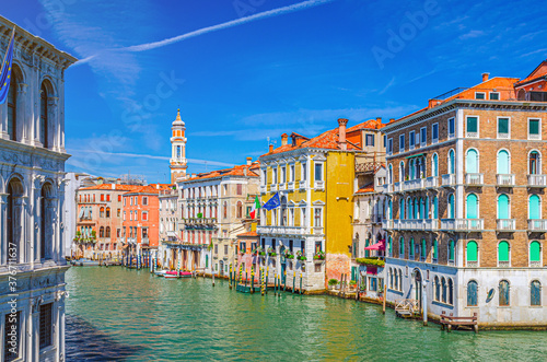 Grand Canal waterway in Venice historical city centre with Palazzo Civran palace, Venetian colorful buildings and Church of the Holy Apostles of Christ bell tower. Veneto Region, Northern Italy. © Aliaksandr