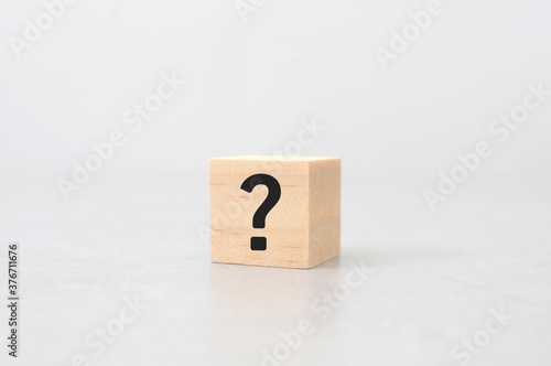 question mark sign and symbol wood cube on cement table white background	