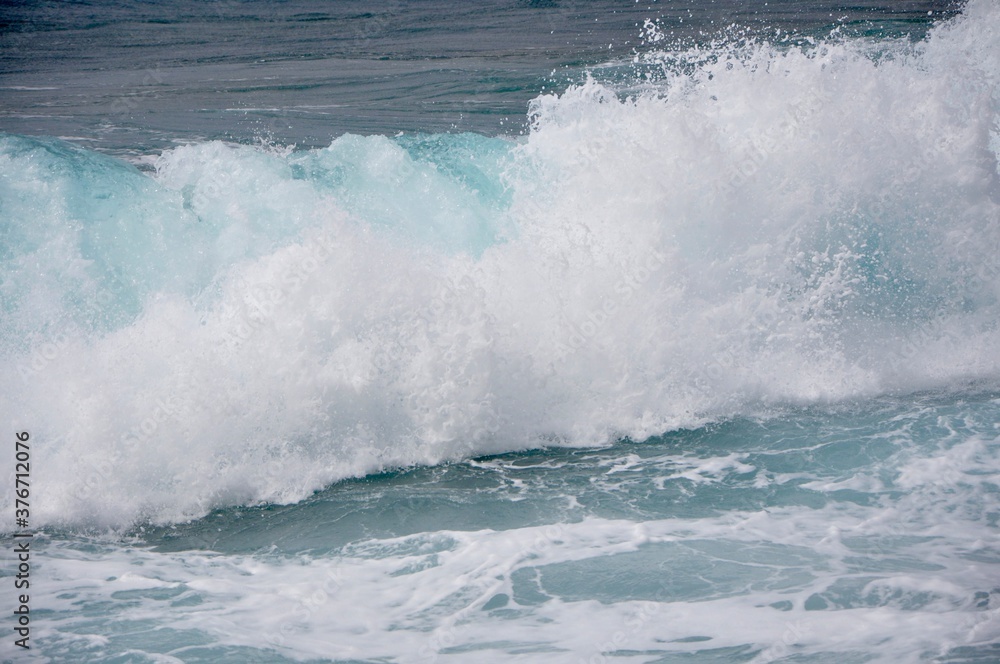Big waves breaking on shore - wave splashing on rock.