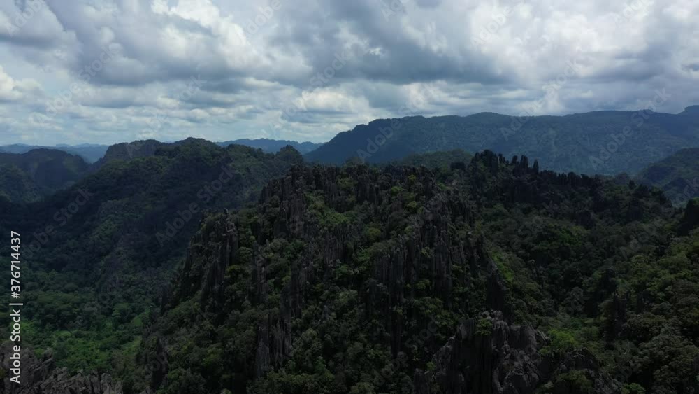 The lush green rainforest in the jungle and its karst peaks in Asia, Laos, Borikhamxay, towards Thakek, on a sunny day. The lush green rainforest in the jungle and its karst peaks in Asia, Laos, Borikhamxay, towards Thakek, on a sunny day.