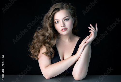 Young beautiful woman with natural makeup on black background. Beauty & Skin care concept. Plus size model. © Romario Ien