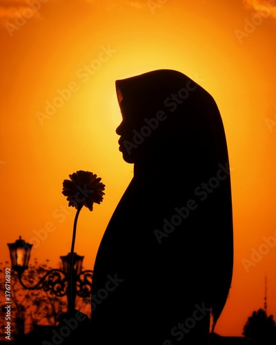 silhouette of a girl with a flower