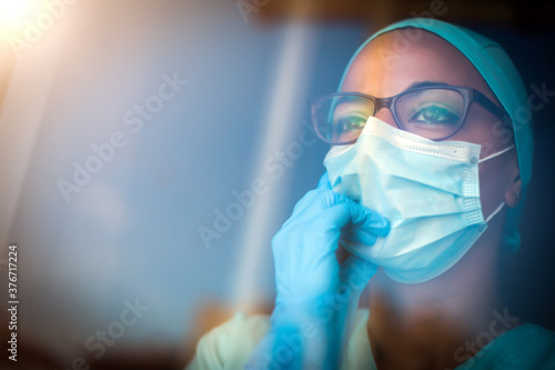 Young female medic, wearing a mask and glasses