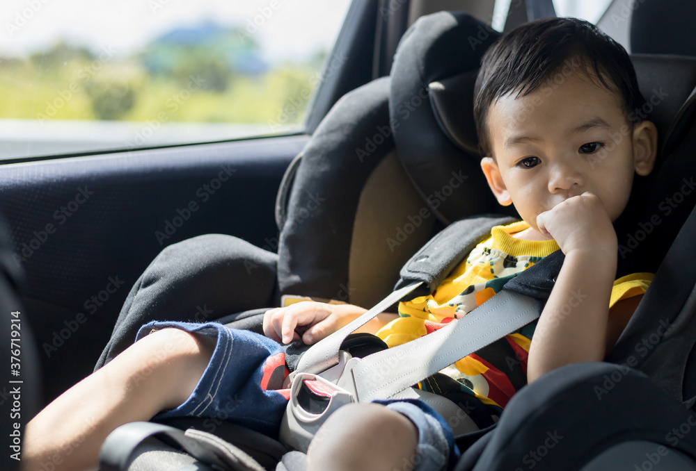 Adorable Asian kid boy (Toddler age 1-year-old) Protection Sitting in the Car Seat with Safety Belt Locked. Adorable Asian kid boy (Toddler age 1-year-old) Protection Sitting in the Car Seat with Safety Belt Locked.