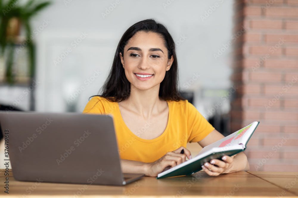 Pretty arab woman looking for job while resting at cafe Pretty arab woman looking for job while resting at cafe