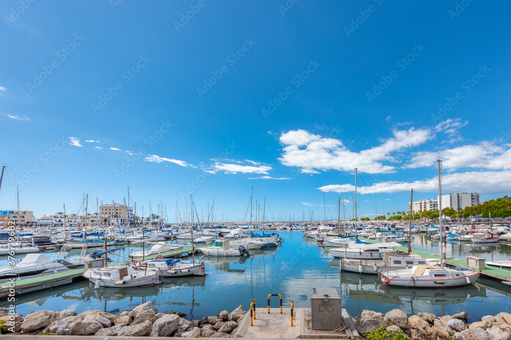 Puerto del Molinar in Palma de Mallorca, with small boats, blue sky