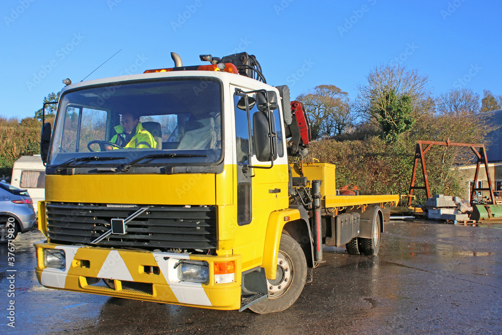 man driving a recovery truck	