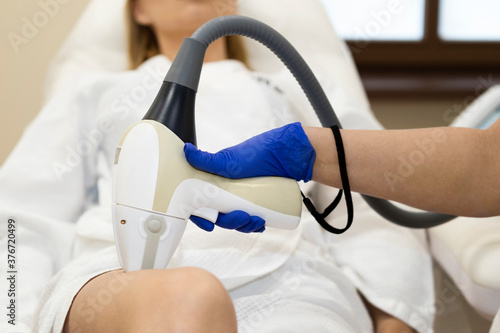 hair removal on the leg with a laser device in the medical center
