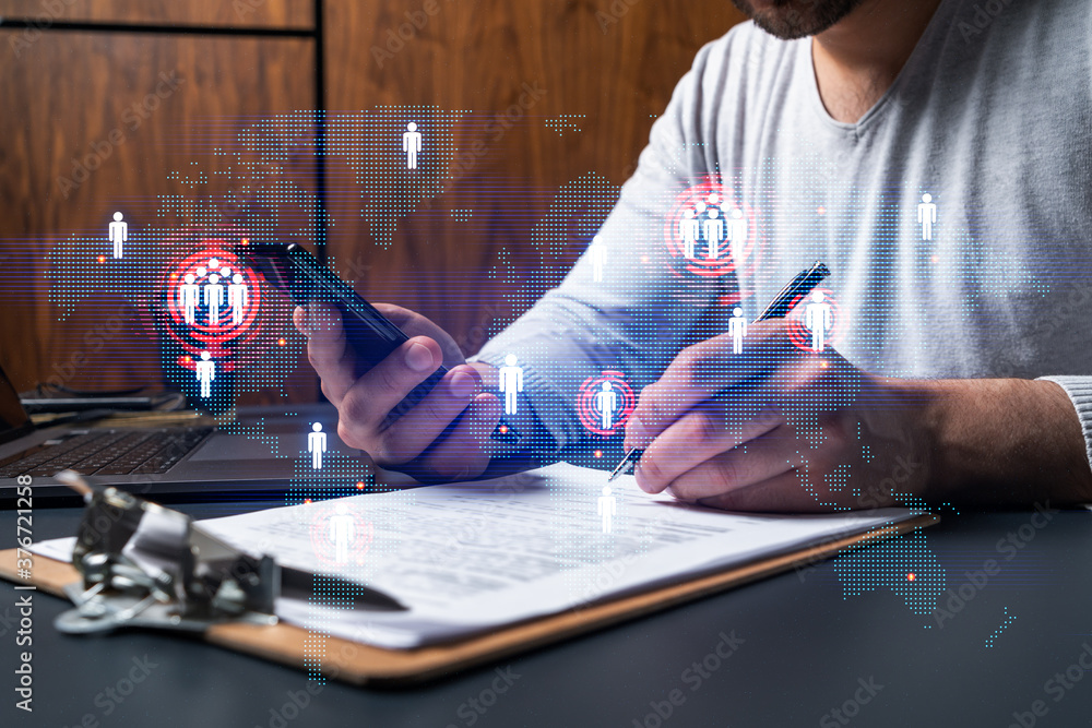 Double exposure of man signing contract with phone and world map ...