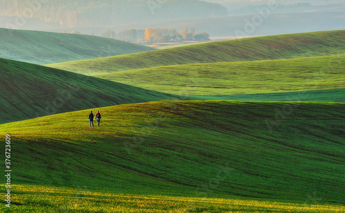 Tourist enjoys the rural landscape. Hills and farmland © sergnester