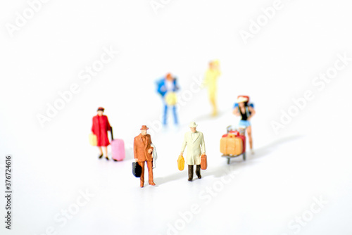 Close up of Miniature backpacker and tourist people on white background. Elegant Design with copy space for placement your text, mock up for travel concept