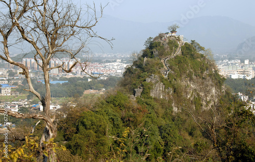 Mt Diecai in Guilin, Guangxi Province, China. This is the summit of Mt Diecai with a path leading to the pavilion at the top. The city of Guilin is behind. photo