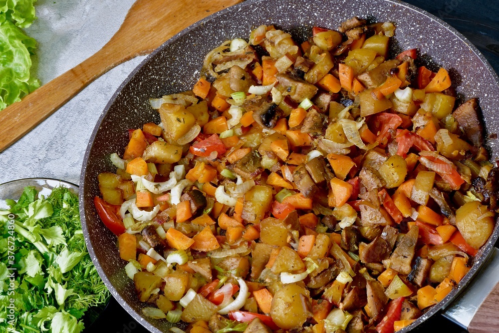 Cooking vegetables and champignons with sauce in a pan Cooking vegetables and champignons with sauce in a pan