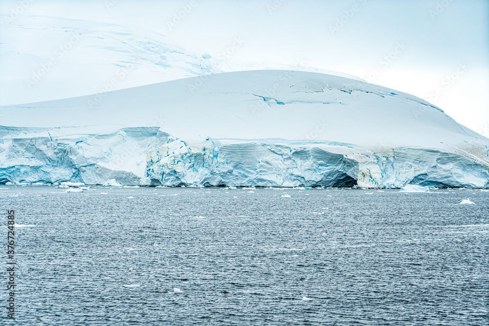 Antarctica, Antarctic Peninsula, cruising in the Lemaire Channel. Ice covered mountain and ice floes.  2020 