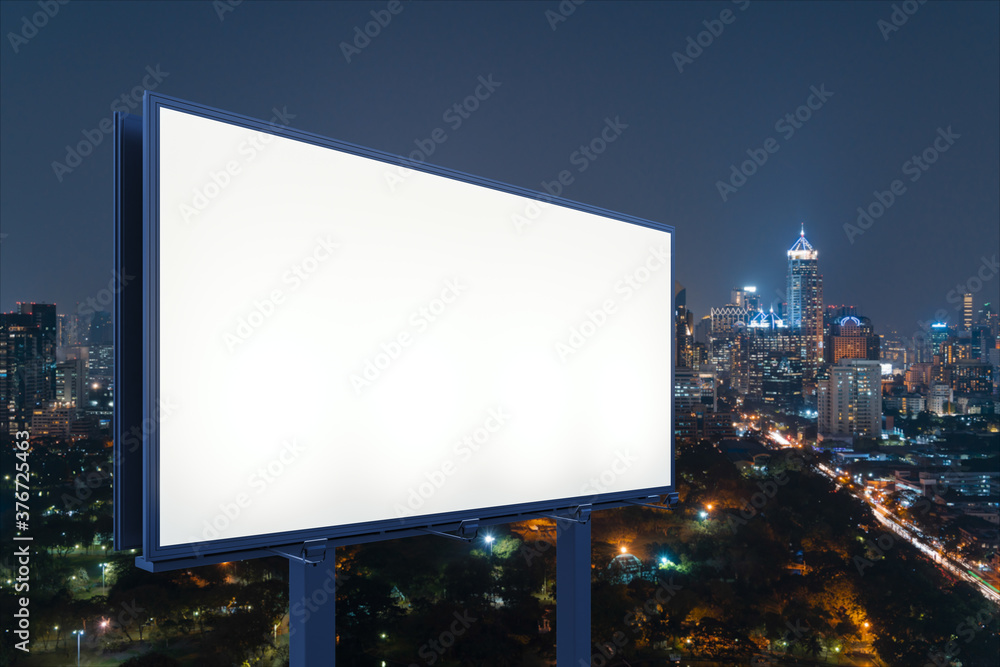 Fototapeta premium Blank white road billboard with Bangkok cityscape background at night time. Street advertising poster, mock up, 3D rendering. Side view. The concept of marketing communication to sell idea.