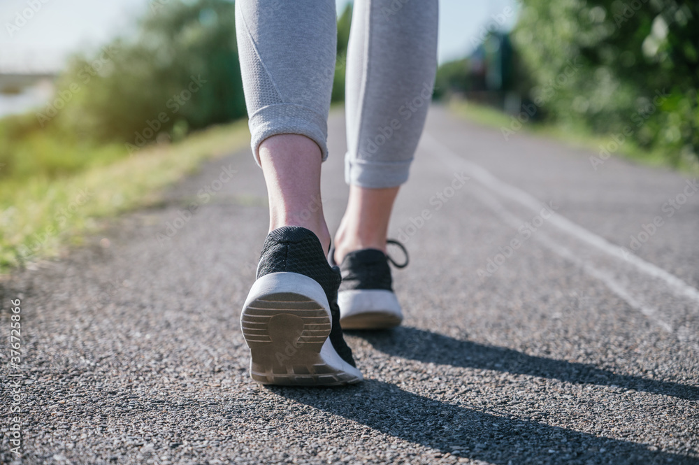Walking feet of a woman with sports shoes Walking feet of a woman with sports shoes