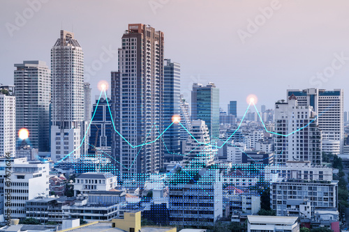 Financial stock chart hologram over panorama city view of Bangkok  business center in Asia. The concept of international transactions. Double exposure.