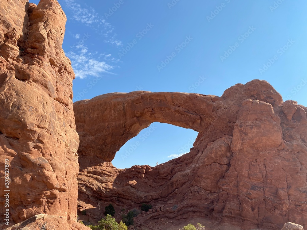 Man Walking In Middle Of The South Window Arch (Arches National Park, UT)