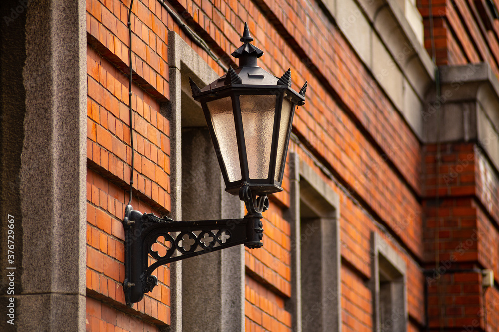 Vintage black gothic street wall lantern in old town of Riga (Vecriga), Latvia.