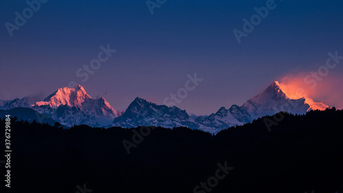 The majestic Kanchenjunga range of the himalayas at first light of sunrise at Sikkim , India photo