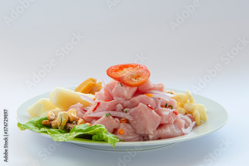 Traditional seafood ceviche from Peru with chili peppers, chickpeas. White background. photo