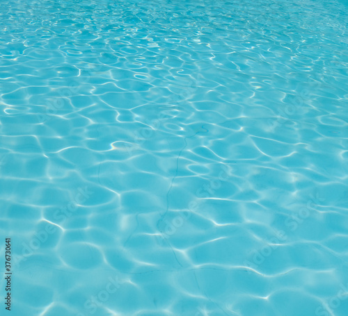 Blue rippled water in swimming pool.