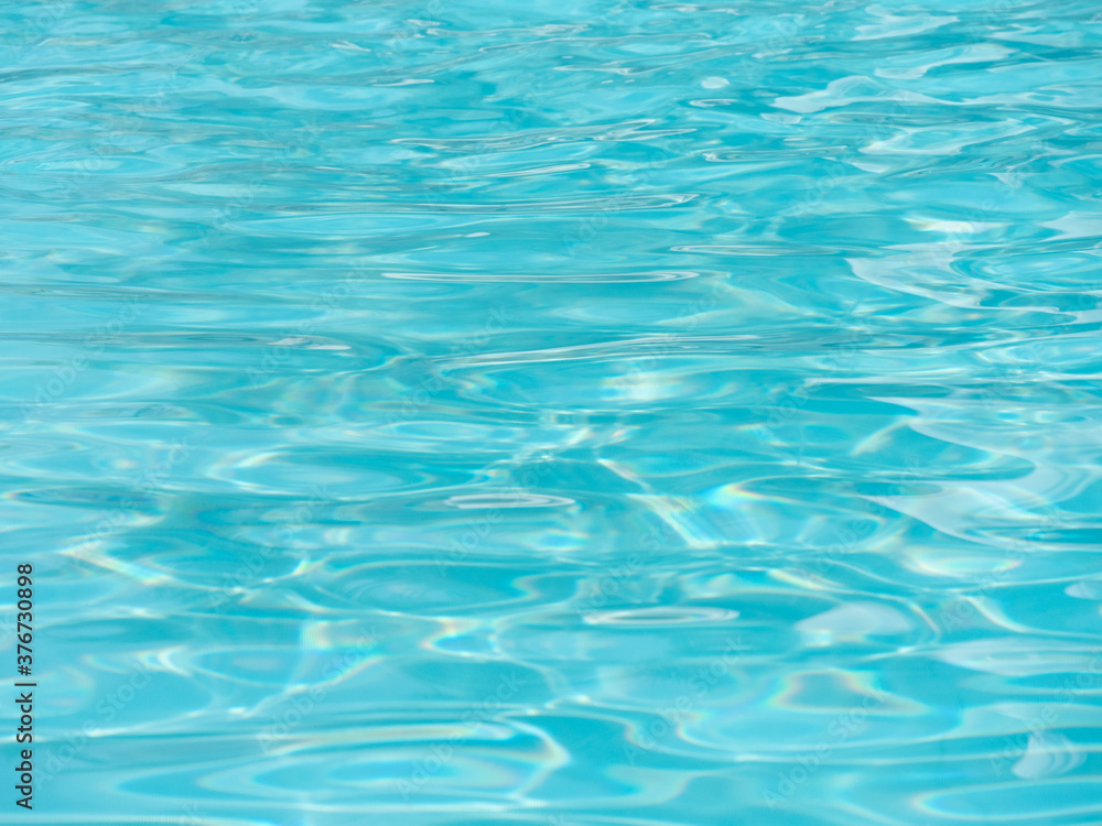 Shiny bright blue water surface in the swimming pool with waves. Shiny bright blue water surface in the swimming pool with waves.