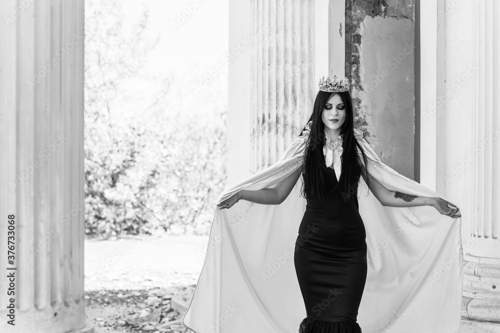 Halloween outfit for lady. Beautiful young woman in black modern dress