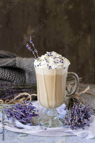 Hot lavender raf latte cappuccino with dried lavender on wooden table. Good Morning concept. Selective focus.
