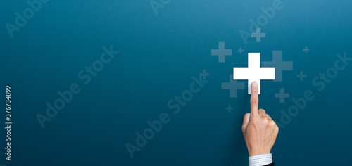 Fototapeta Naklejka Na Ścianę i Meble -  Businessman pushing button positive thing. Business for Profit, Benefit, health insurance, Development and growth concepts. Represented by a plus sign with copy space