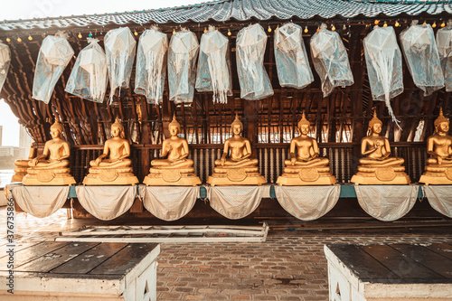 Golden Buddha statues in a Buddhist temple. © insomniafoto