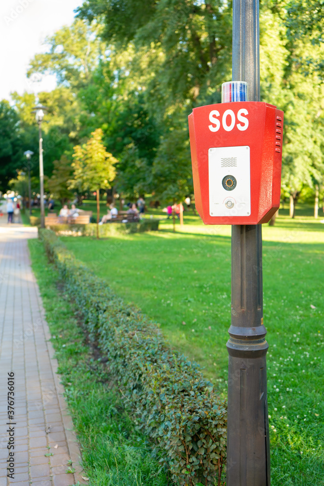 SOS, police, emergency button in the public park. SOS, police, emergency button in the public park.