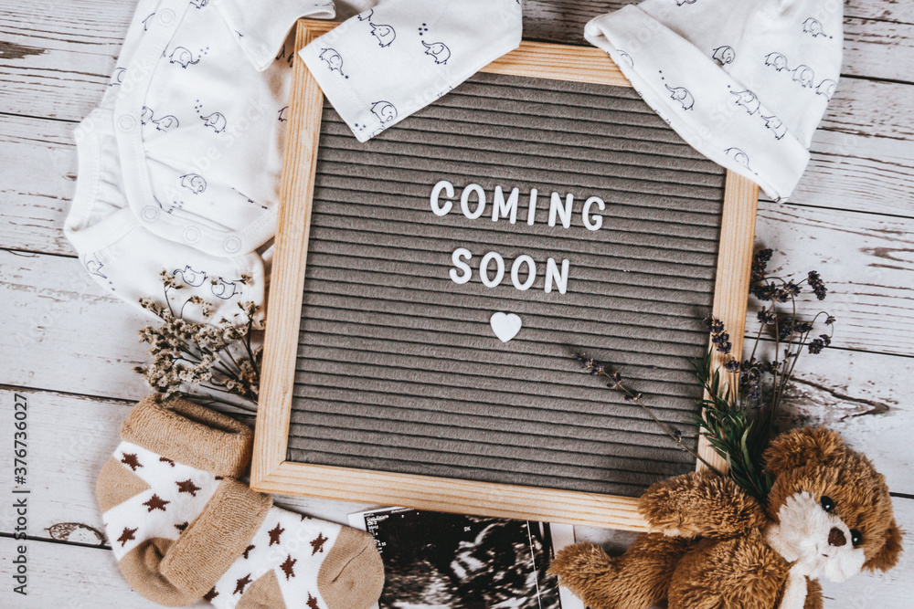 Coming soon sign. Baby announcement sign on a rustic white background