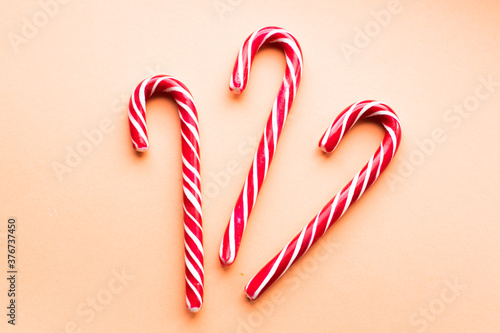 three multi-colored Christmas candies on a colored background. sweets for Christmas and new year