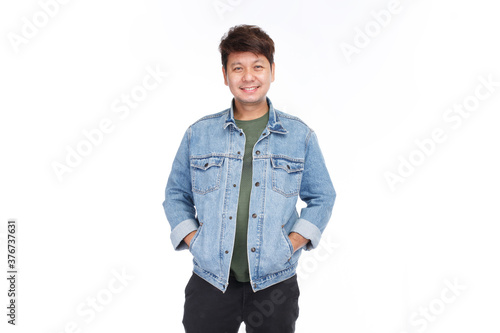 Asian man with authentic skin and big smile face look at camera, put hands in pocket of blue jeans jacket, isolated on white background