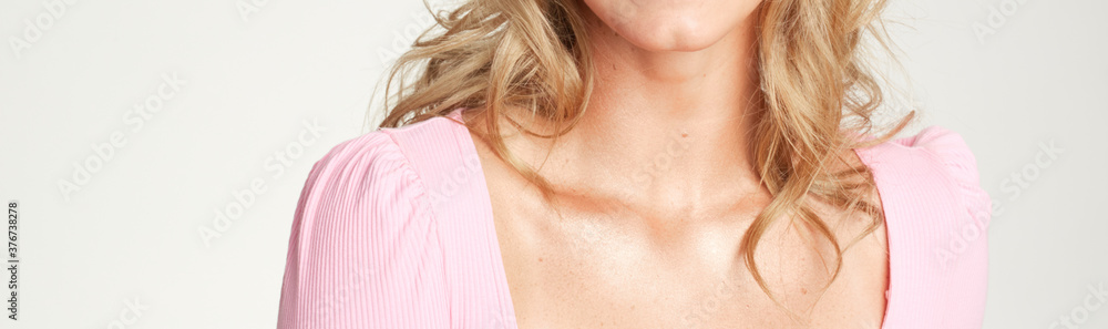 Beauty skin care image of white girl with blonde hair wearing a pink shirt showing collarbone and chin Beauty skin care image of white girl with blonde hair wearing a pink shirt showing collarbone and chin