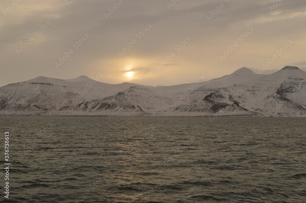 Winter sunset over the ice fjords of the Archipelago of Svalbard (Spitsbergen) in Norway Winter sunset over the ice fjords of the Archipelago of Svalbard (Spitsbergen) in Norway